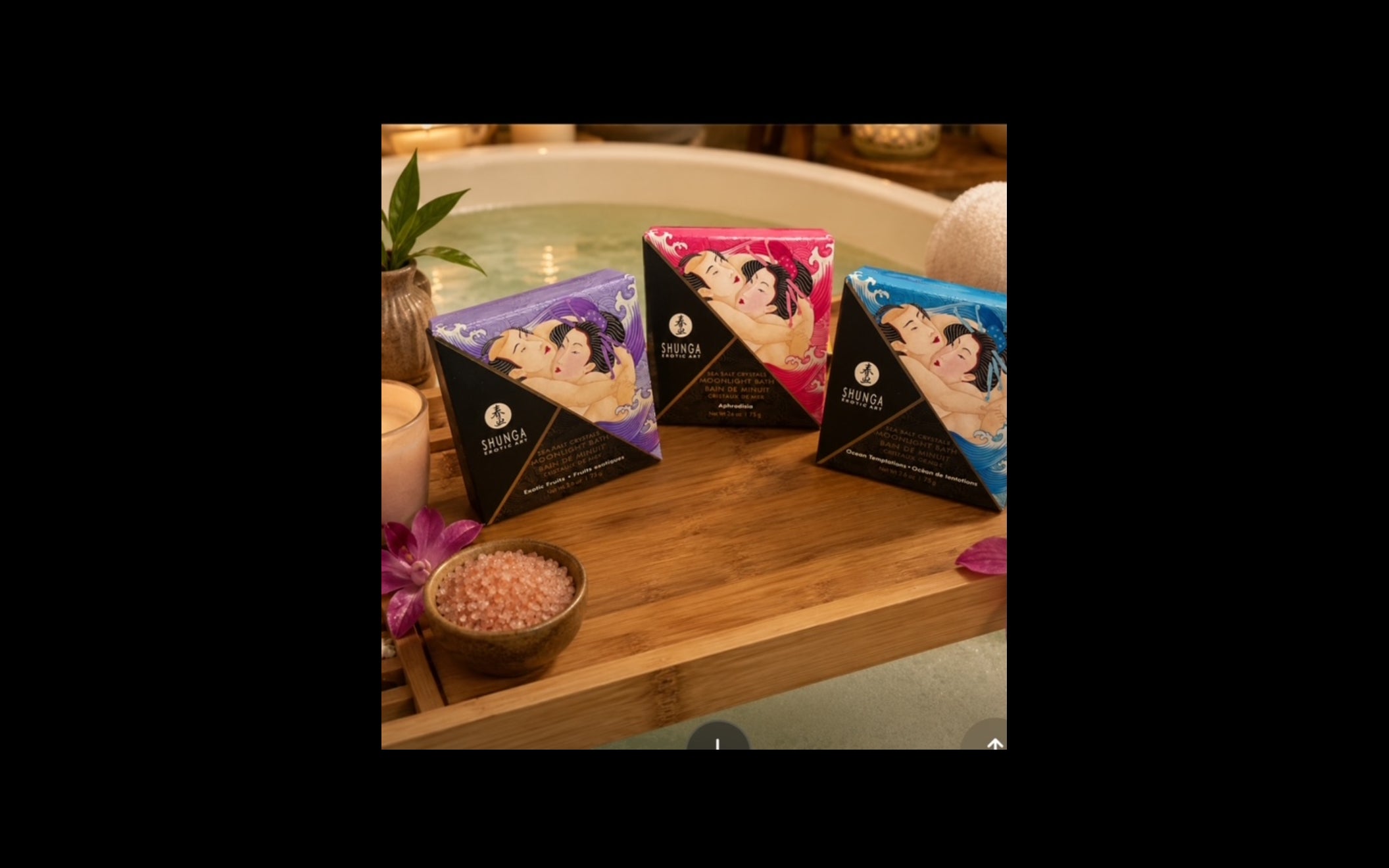 Shunga Dead Sea Salt bath salts collection displayed on bamboo tray by bathtub